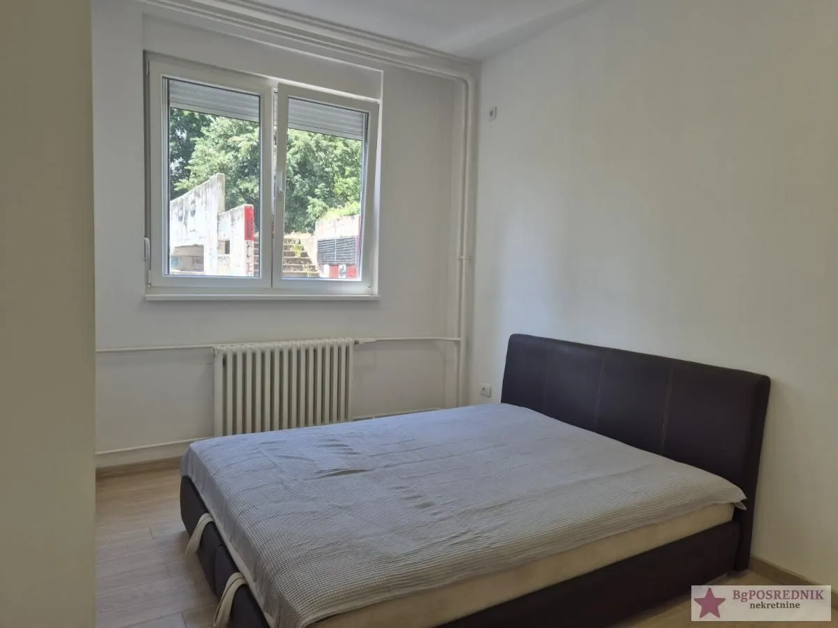 Bedroom with a double bed and a window.