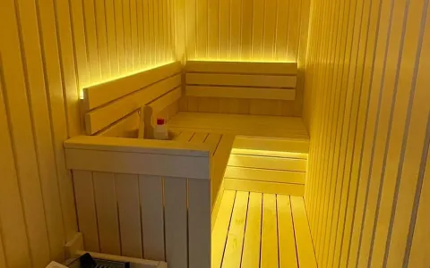Wooden sauna with lighting and benches. - image 9