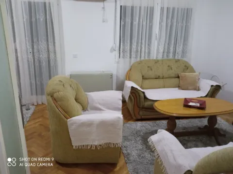 A living room with a seating set and a wooden coffee table. - image 2