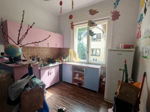 Small kitchen in pink and blue tones with cabinets and a refrigerator. - image 3