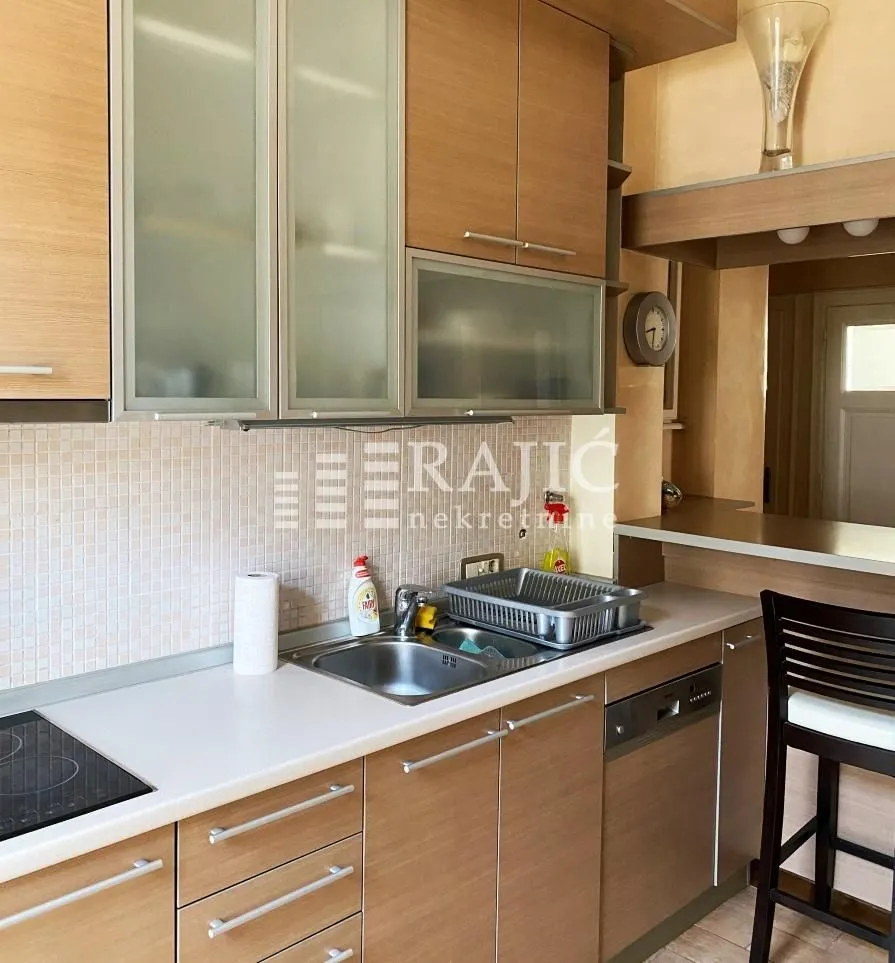 Wooden kitchen cabinets with a sink and countertop.