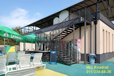 Exterior view of the building with stairs and sun loungers by the pool. - image 7