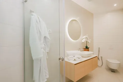 Modern bathroom with a washbasin, shower cabin, and wall-mounted toilet. - image 17