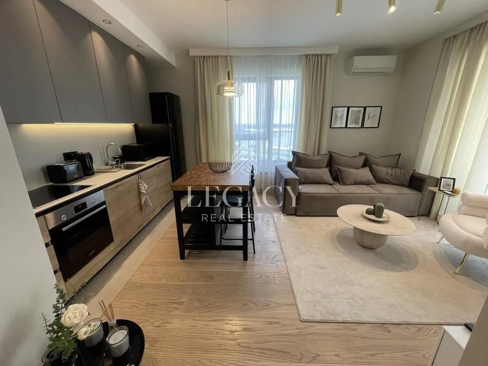 Open-plan living room with a kitchen and dining table.