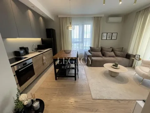 Open-plan living room with a kitchen and dining table. - image 2