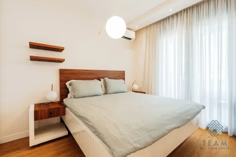 Modern bedroom with a double bed and a nightstand. - image 7