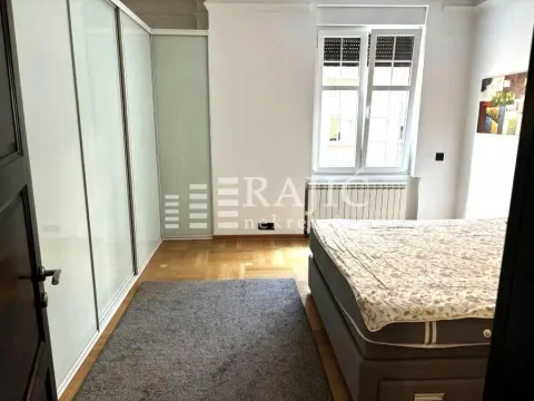Bedroom with a large double bed, wardrobe, and window. - image 9