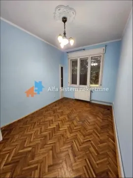 An empty room with blue walls and herringbone parquet flooring. - image 2