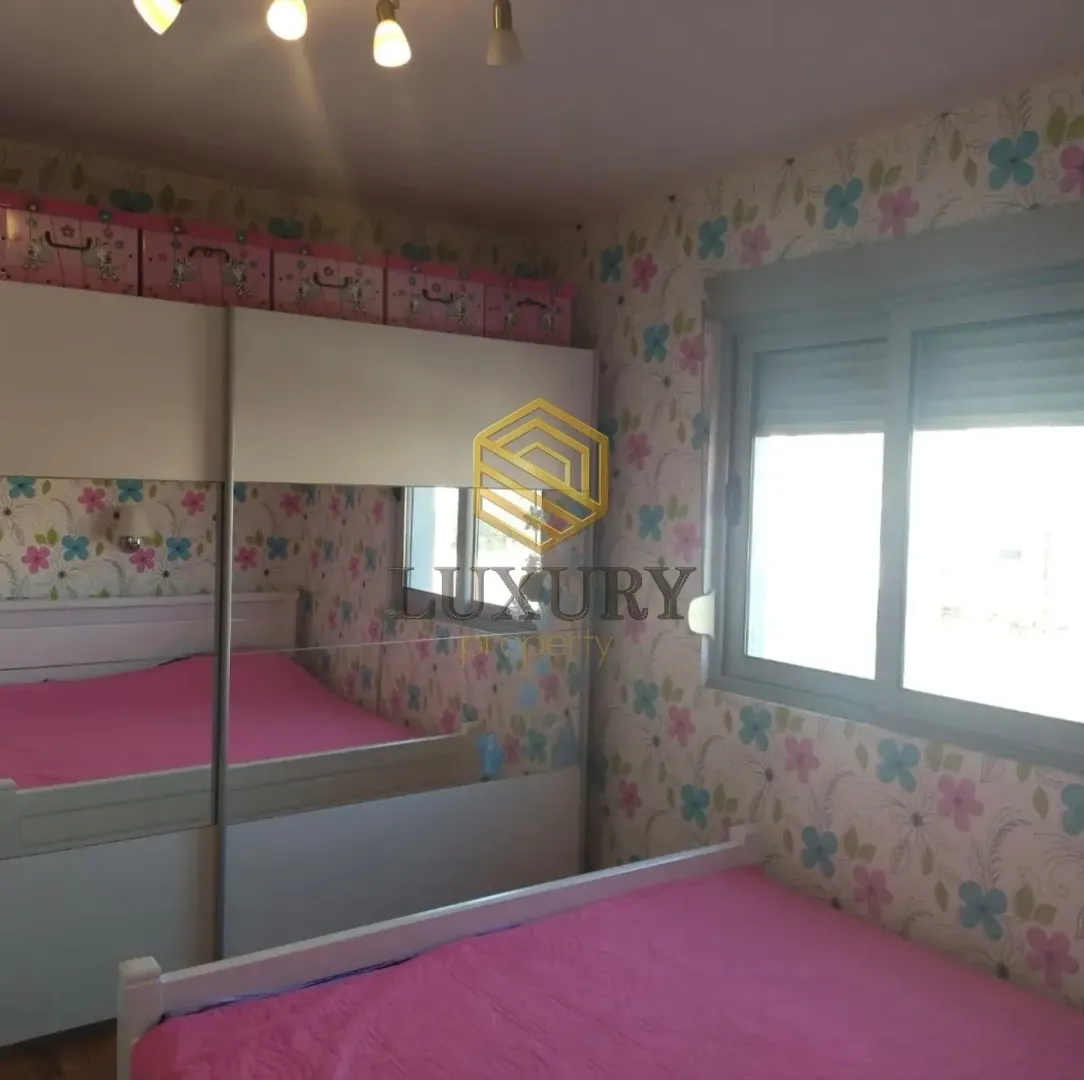 Children's bedroom with a bed and wardrobe.