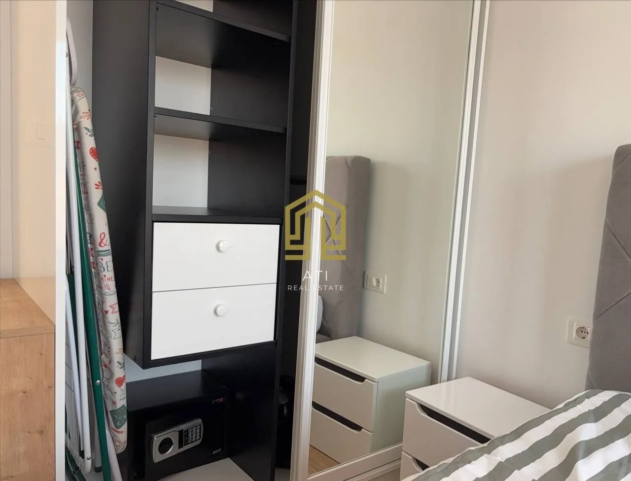 Bedroom with a bed, wardrobe, and nightstand.