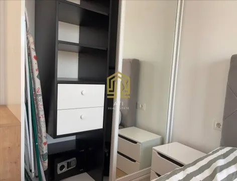 Bedroom with a bed, wardrobe, and nightstand. - image 10