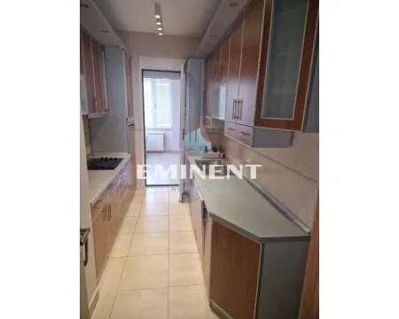 Narrow kitchen with wooden cabinetry and appliances. - image 6