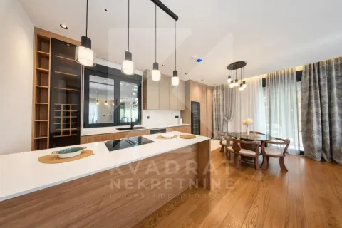 Modern kitchen with a large island and dining area in an open-plan space. - image 21