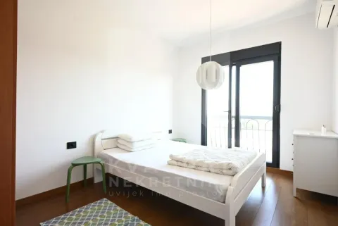 Bright bedroom with a white bed and access to the terrace. - image 9