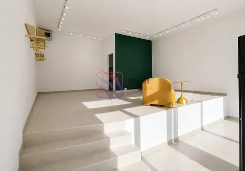 Spacious bright living room with a raised area and a yellow armchair. - image 2