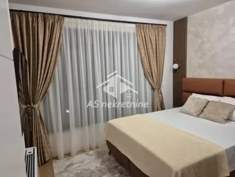 Modern bedroom with a double bed and a large window with curtains. - image 18