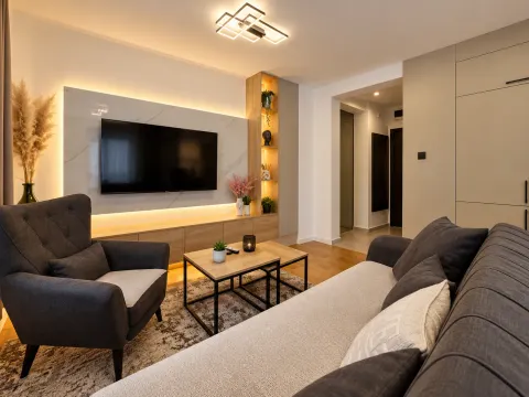 Living room with sofa, armchair and TV unit with decorative lighting. - image 14