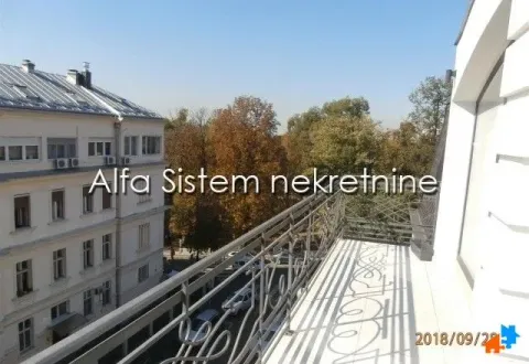 Spacious balcony with a view of surrounding buildings and trees. - image 24