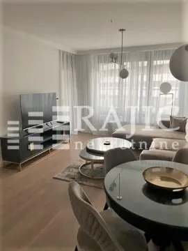 Modern living room with a sofa, TV unit, and dining table. - image 9
