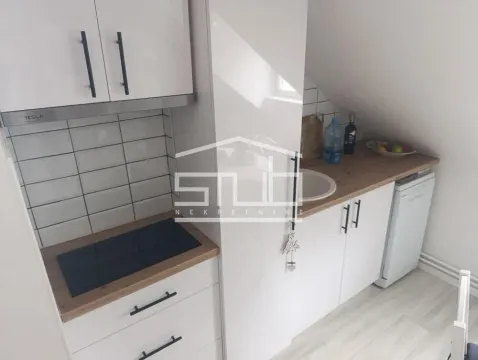 Small white kitchen with wooden countertops and built-in units. - image 9