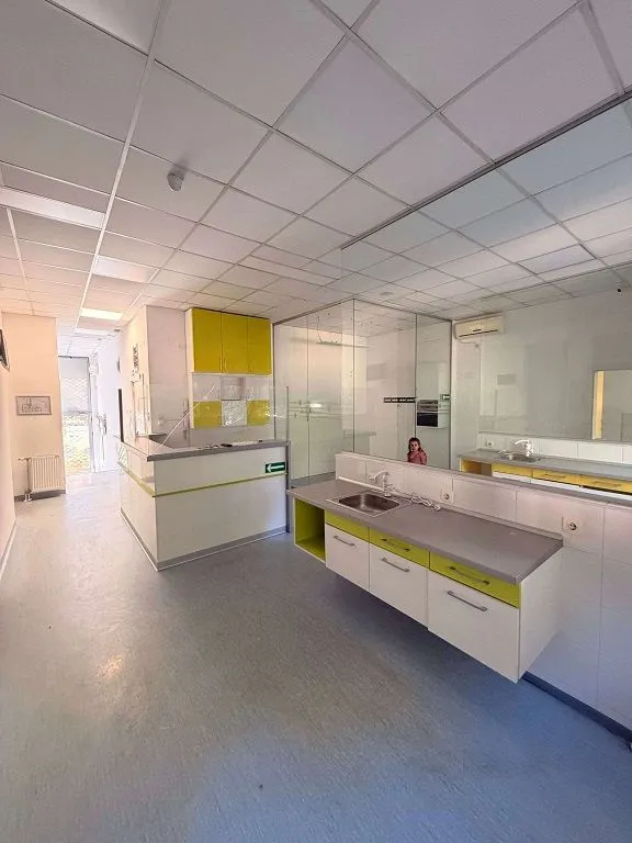 Spacious commercial room with kitchen units and a counter.