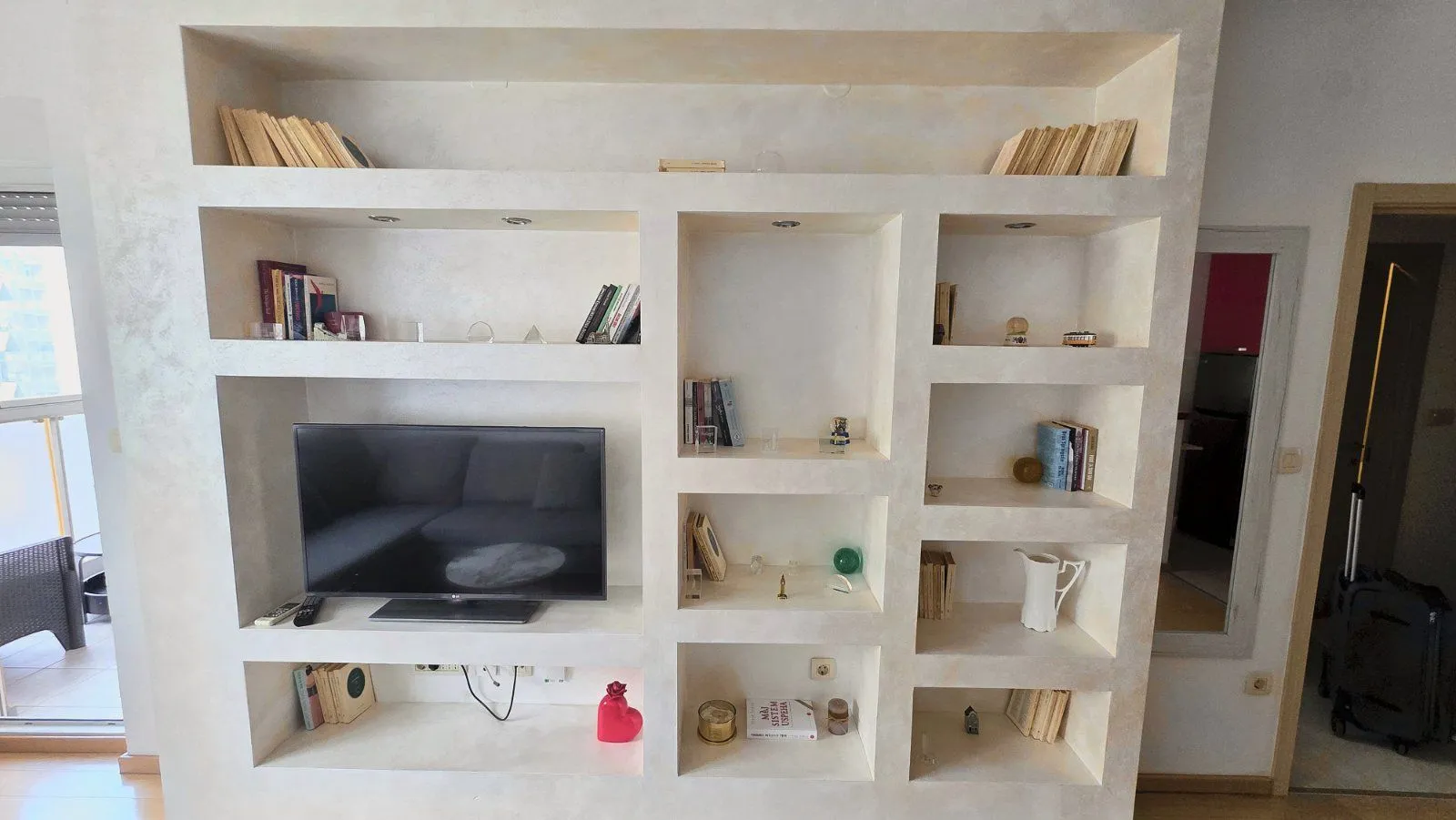Living room with a built-in bookshelf and television.