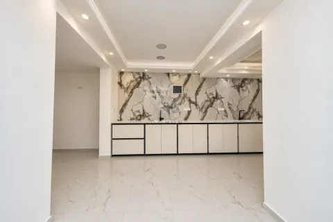 Modern kitchen with white cabinets and marble-look wall panel. - image 10