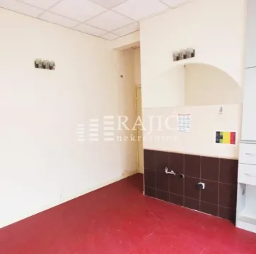Empty kitchen with ceramic tiles and a red floor. - image 4
