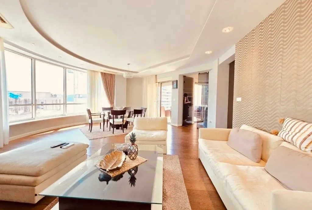 Spacious and bright living room with a sofa set and dining area.