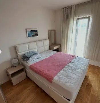 Bedroom with a double bed, bedside table, and balcony access. - image 9