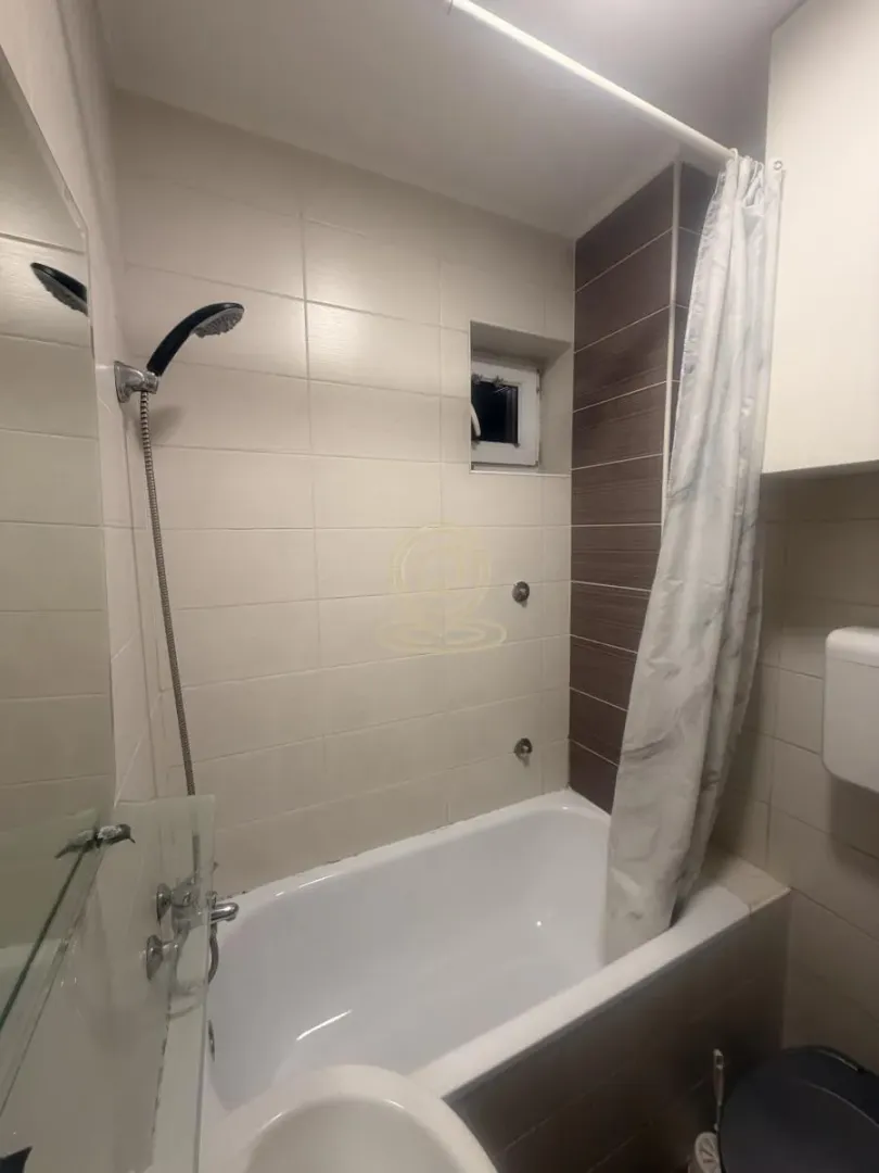 Bathroom with a bathtub, shower, and sanitary ware.