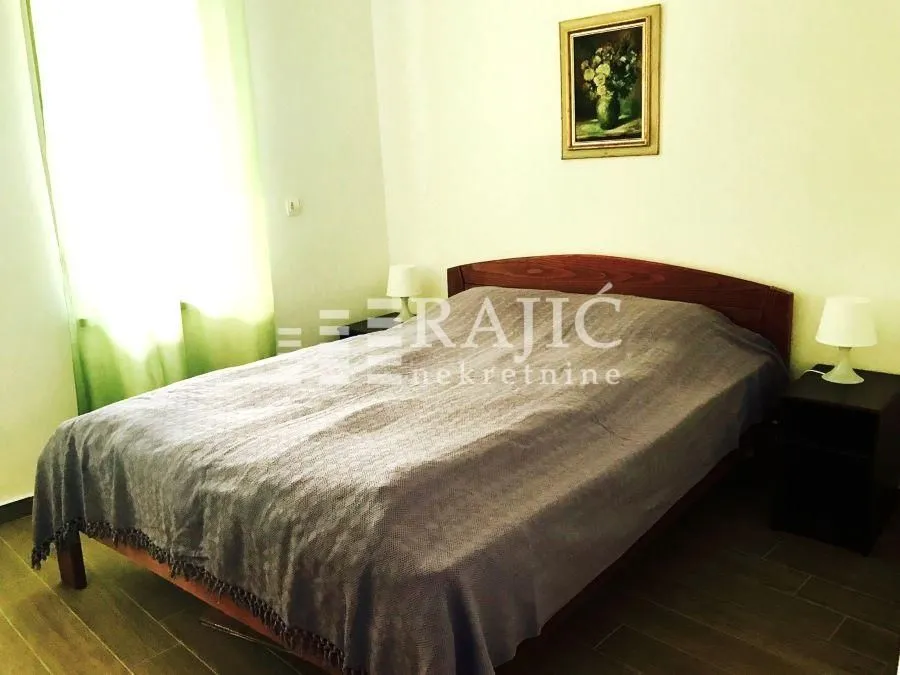 Furnished bedroom with a double bed and bedside tables.