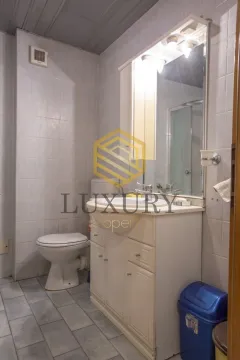 Small bathroom with a vanity, cabinet, mirror, and toilet. - image 8