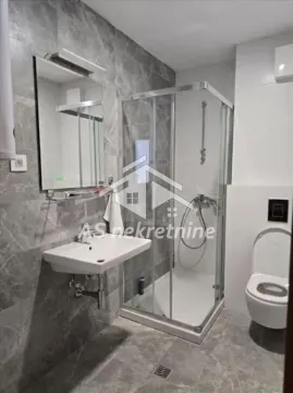 Modern bathroom with a shower cabin, washbasin, and toilet. - image 13