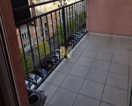 Prostrana popločana terasa sa metalnom ogradom i pogledom na ulicu. - image 15
