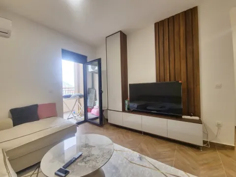 Living room with sofa, television and balcony access. - image 8