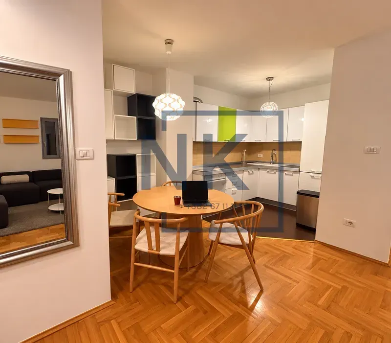 Dining area with a wooden table and chairs, connected to the kitchen.