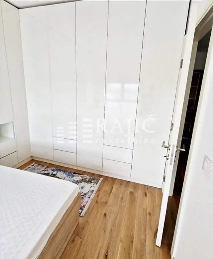 Bedroom with a large fitted wardrobe and a bed.