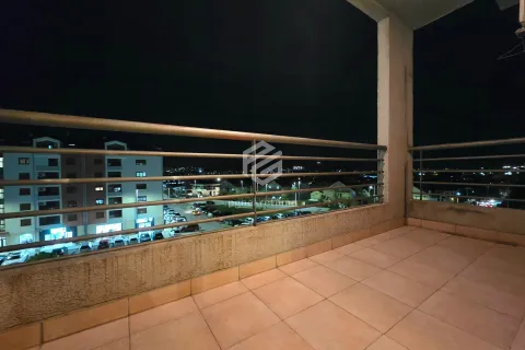 Unfurnished balcony with a view of the city at night and parking. - image 5