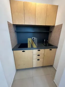 Small wooden kitchen with sink, hob, and upper cabinets. - image 8