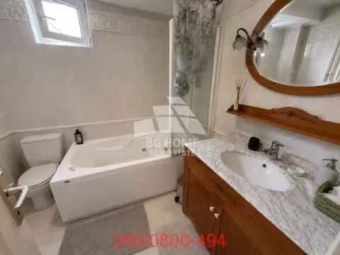 Bathroom equipped with a bathtub, washbasin, and toilet. - image 6