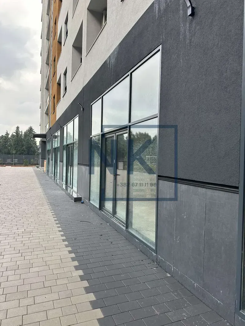 Exterior of a commercial space on the ground floor of the building with large glass display windows.