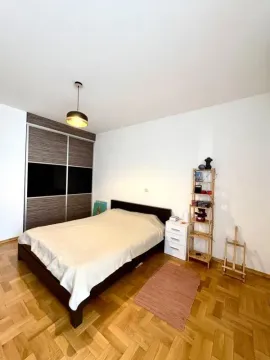 Bedroom with a double bed, wardrobe, and wooden flooring. - image 2