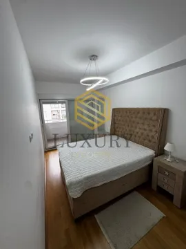 Furnished bedroom with a double bed and balcony access. - image 10