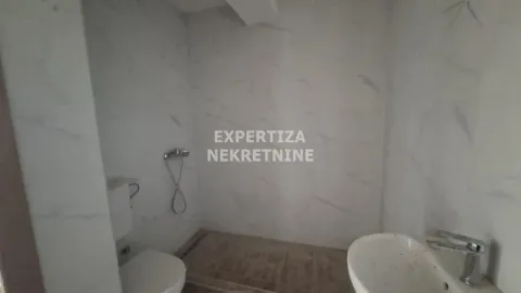 Small furnished bathroom with white ceramic tiles and sanitary ware. - image 7