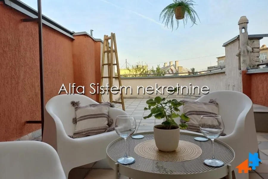 Spacious rooftop terrace with seating furniture and city views.