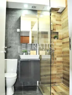 Modernly equipped bathroom with a walk-in shower. - image 14