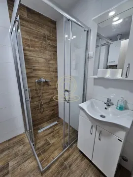 Bathroom with a shower cabin, washbasin, and mirror. - image 5