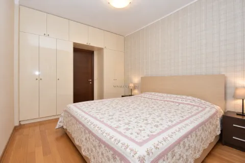 Furnished bedroom with a double bed, built-in wardrobe, and nightstands. - image 6