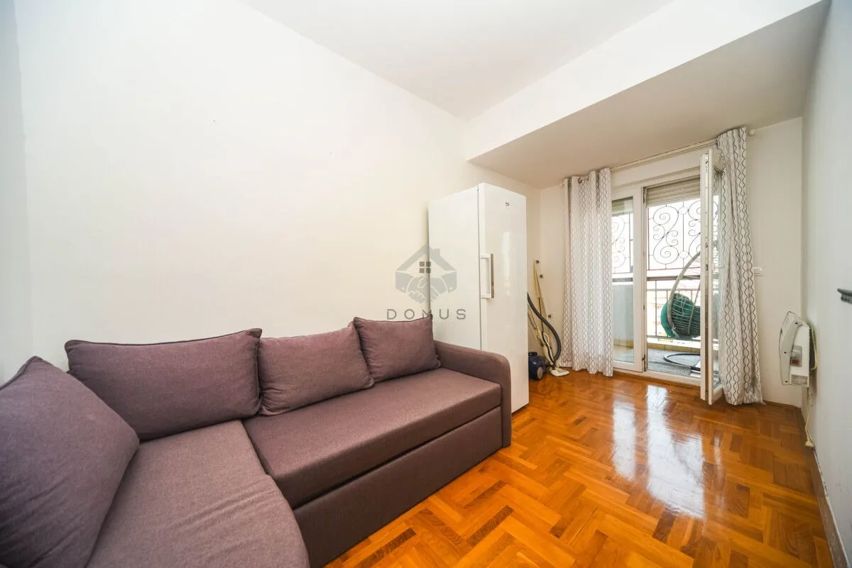 Living room with a sectional sofa and access to the terrace.